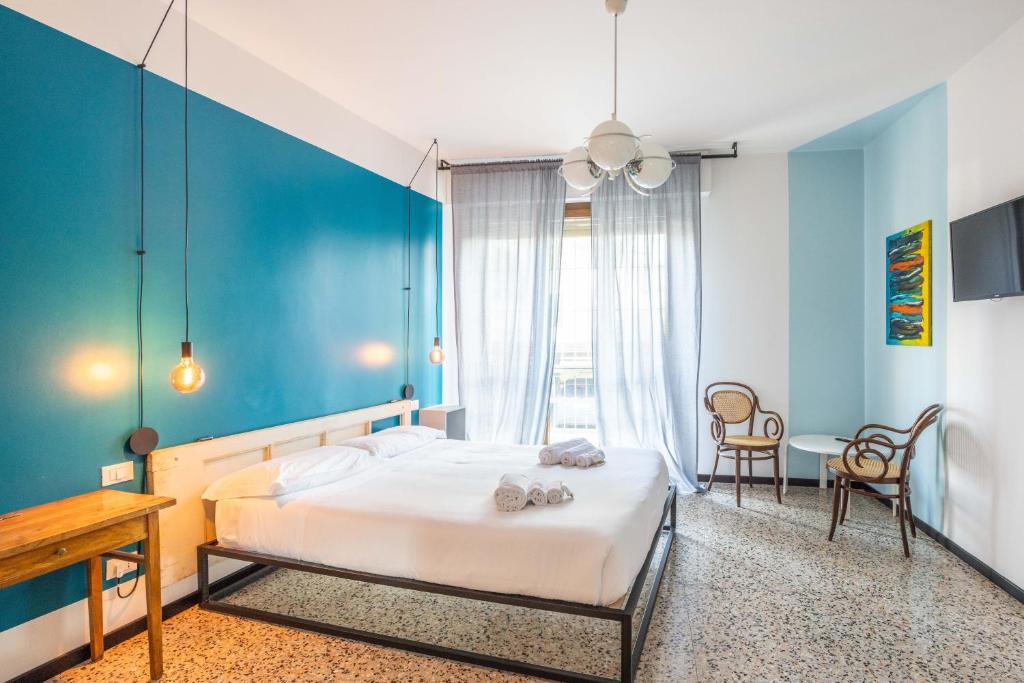 a bedroom with a bed and a blue wall at Le stanze in Fiera, Bologna by Short Holidays in Bologna