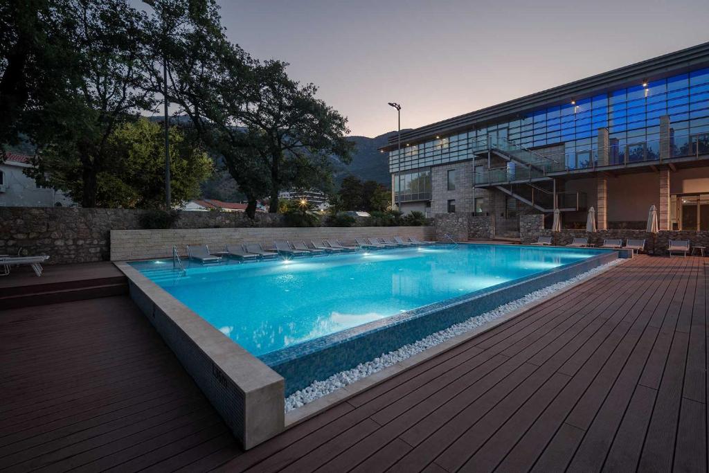 a large swimming pool in front of a building at Eurostars Queen of Montenegro in Budva