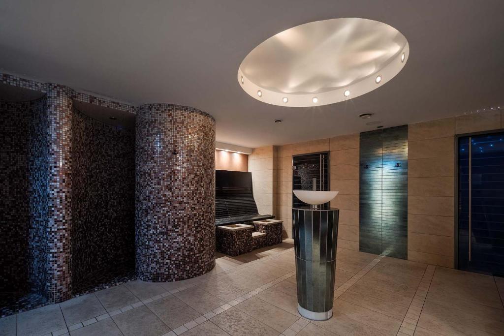 a large room with a ceiling with a light fixture at Eurostars Queen of Montenegro in Budva
