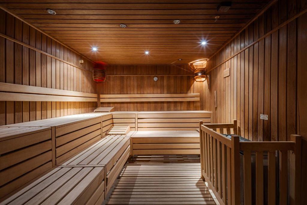 an empty sauna with wooden benches and lights in it at Eurostars Queen of Montenegro in Budva