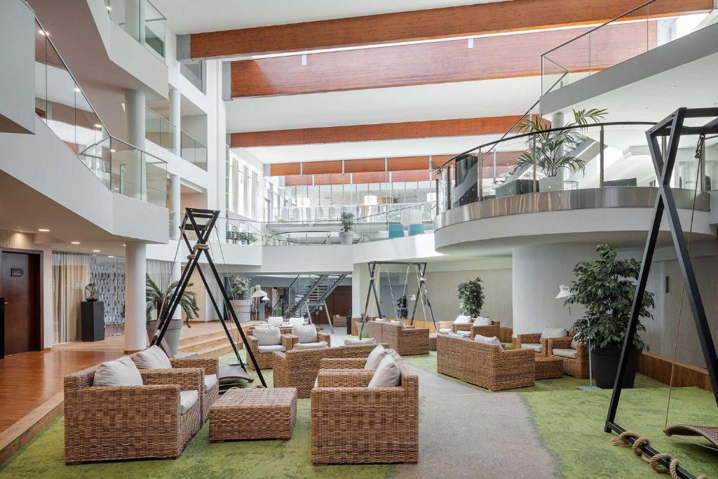 a large lobby with couches and chairs and a staircase at Eurostars Queen of Montenegro in Budva