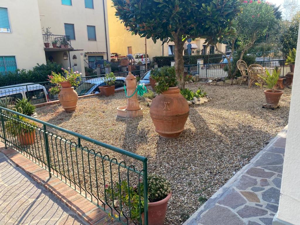 a garden with several large pots of plants at Appartamento Magnolia in Mercatale Val Di Pesa