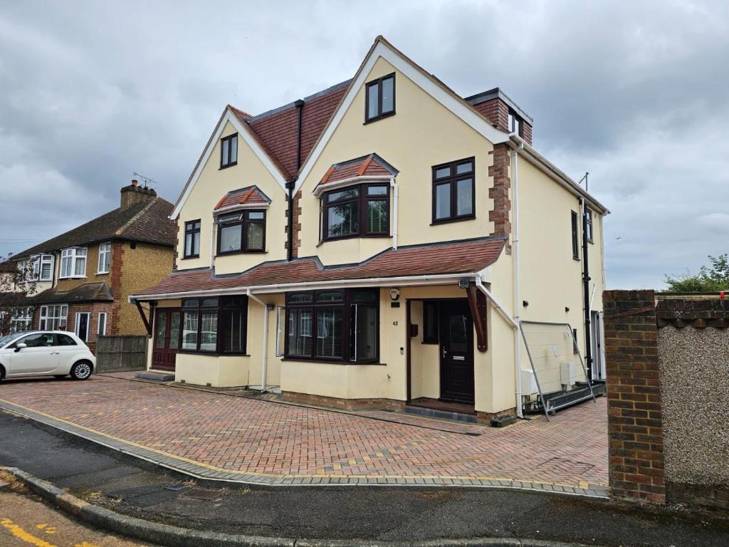 a house with a car parked in front of it at Shortwood Stay in Staines upon Thames