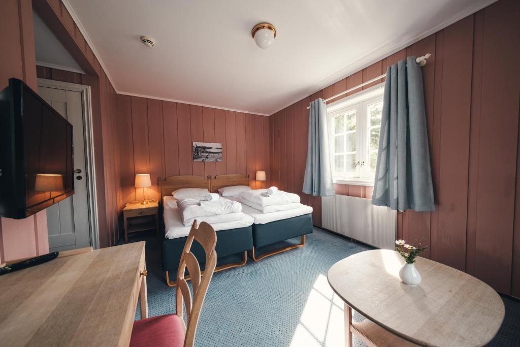 una habitación de hotel con una cama y una mesa en Gålå Høgfjellshotell, en Gålå