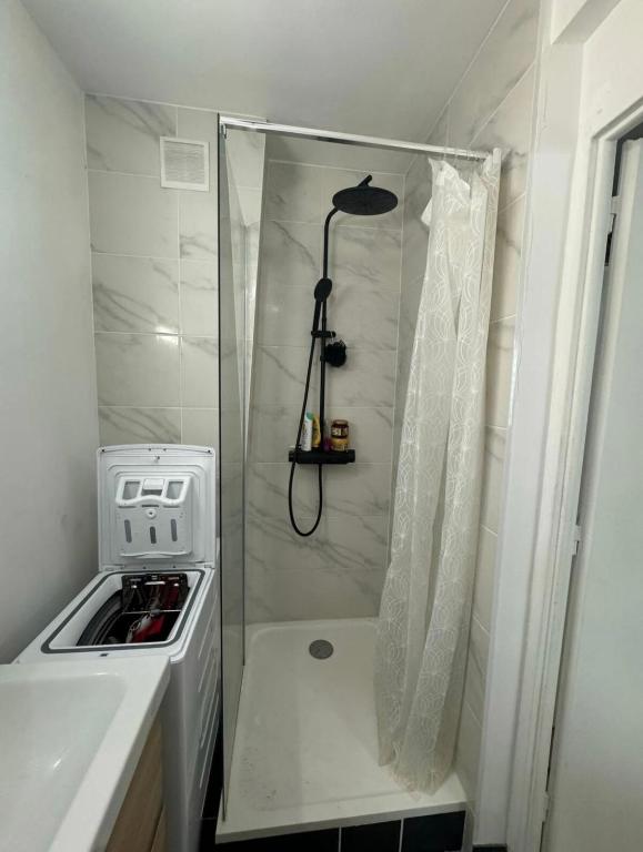 - une douche dans une petite cuisine équipée d'une cuisinière dans l'établissement Studio paris 13, à Paris