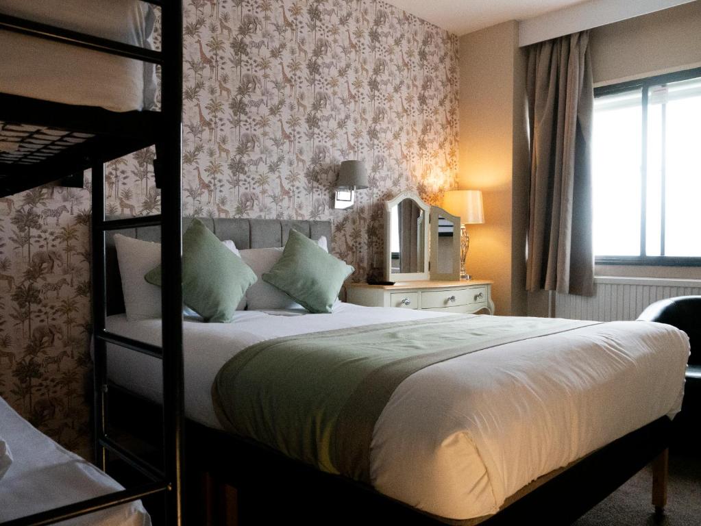 a bedroom with a bed and a bunk bed at Britannia Hotel Newcastle Airport in Newcastle upon Tyne