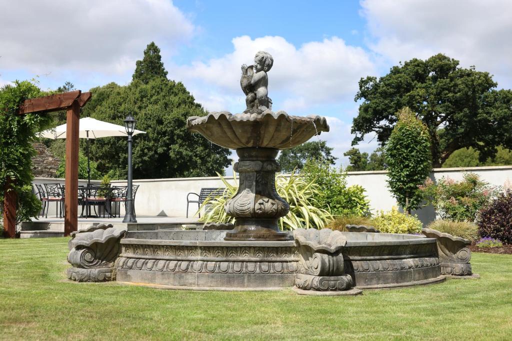 a fountain in the middle of a grass field at Meadowside B&B in Bunclody