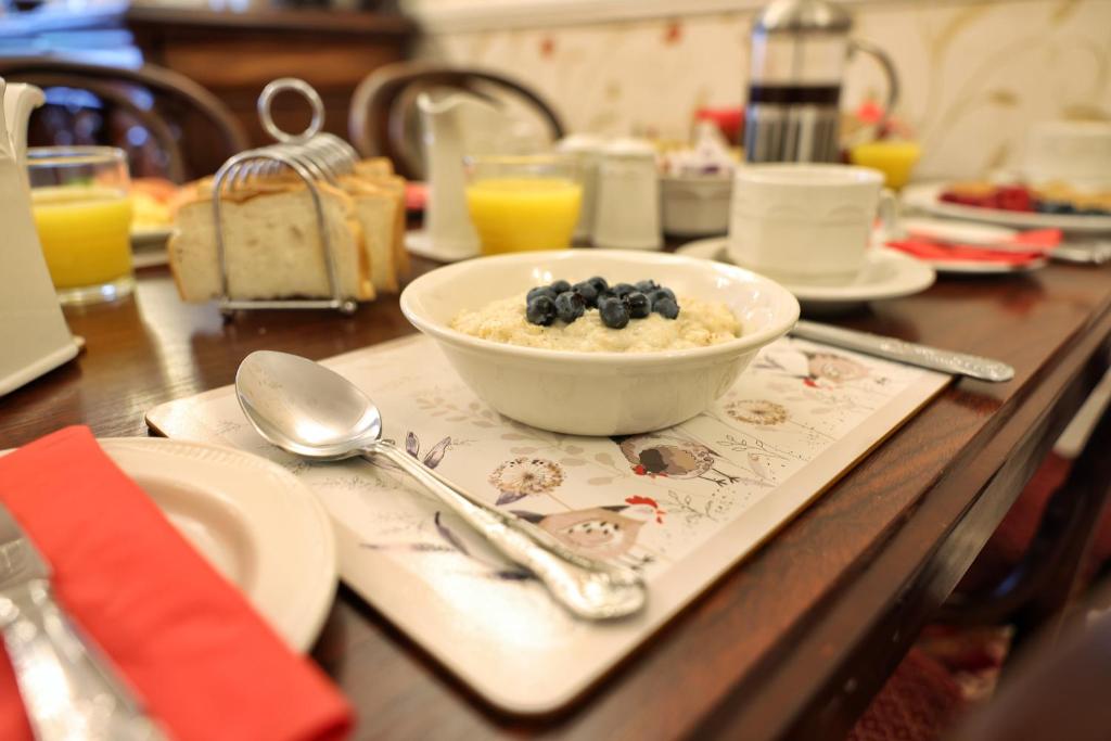 a table with a bowl of oatmeal and blueberries on it at Meadowside B&B in Bunclody