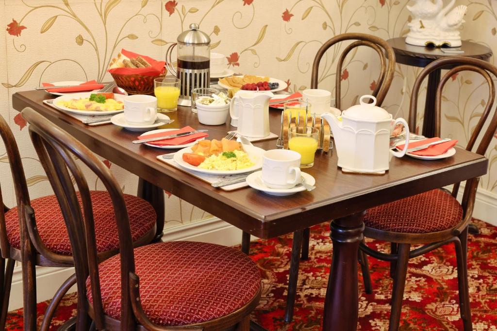 a wooden table with plates of food on it at Meadowside B&B in Bunclody