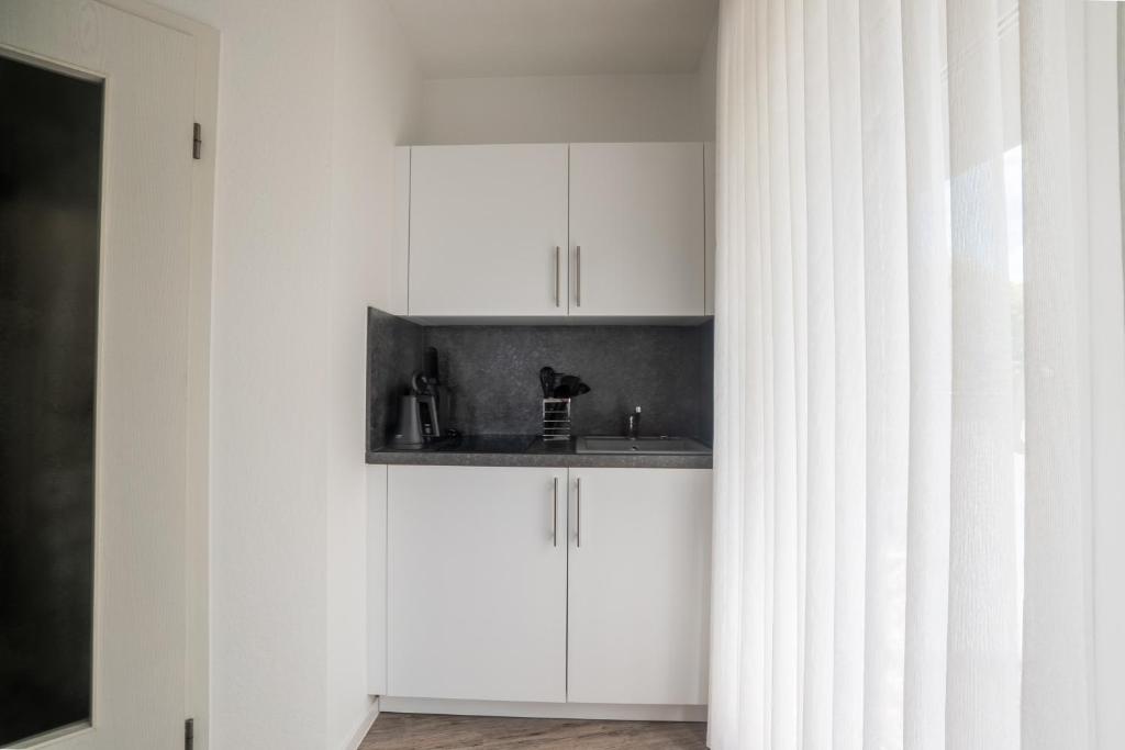 Kuchyň nebo kuchyňský kout v ubytování Appart-Haus Business Apartments