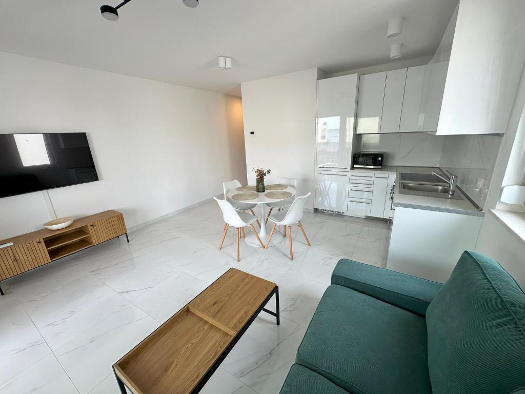 a living room with a couch and a table at Beautiful new PalmTree Apartments in Vir