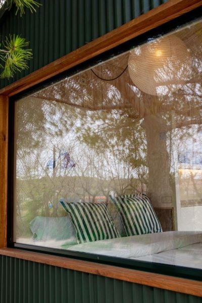 a glass window of a building with pillows in it at Camping 3 Estrellas in Gavà
