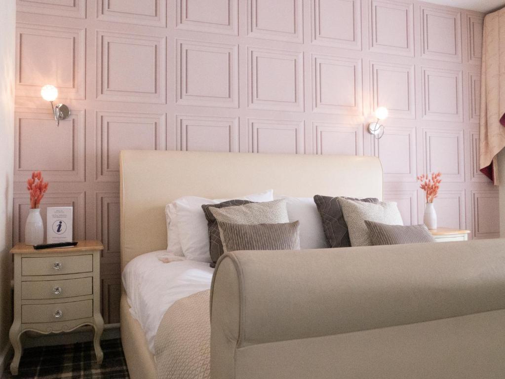 a bedroom with a white bed and a white wall at Britannia Hotel Newcastle Airport in Newcastle upon Tyne