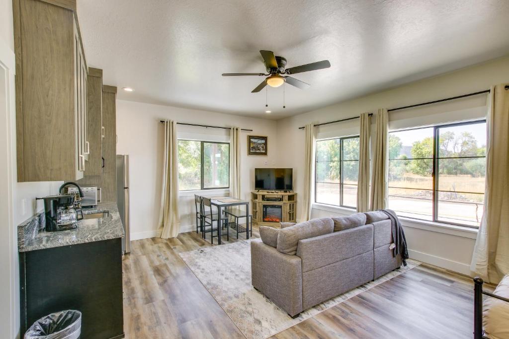 a living room with a couch and a ceiling fan at Near Snowmobiling! Preston Sugar Creek Apartment in Preston