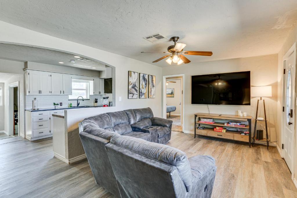 a living room with a couch and a flat screen tv at 4 Mi to Museum of the Great Plains Lawton Home! in Lawton