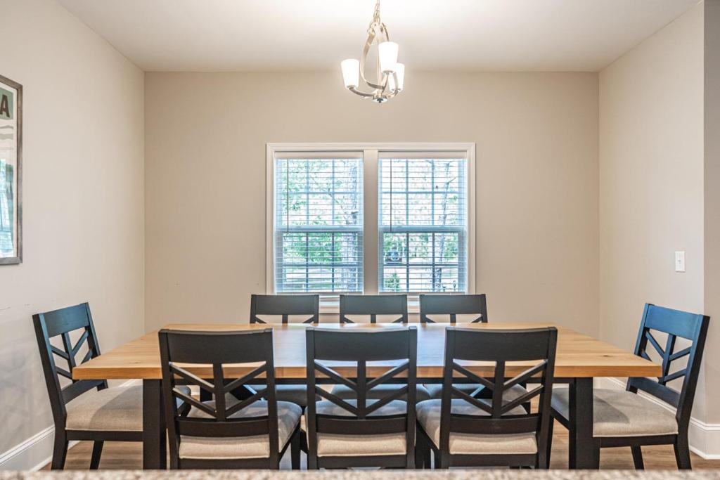 a dining room with a wooden table and chairs at River Birch at Ducks Landing in Aberdeen