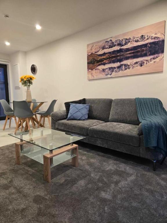 a living room with a couch and a table at CBD Apartment 3 - 2 Bed 2 Bath in Christchurch