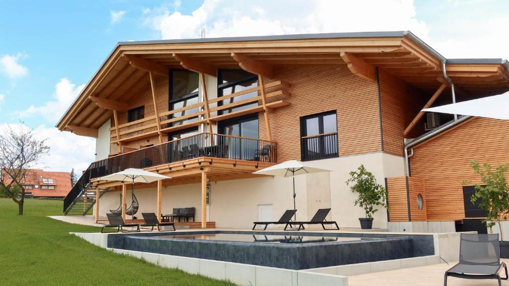 a house with a pool in front of it at Schwarzwald Chalet Auwald in Freiamt