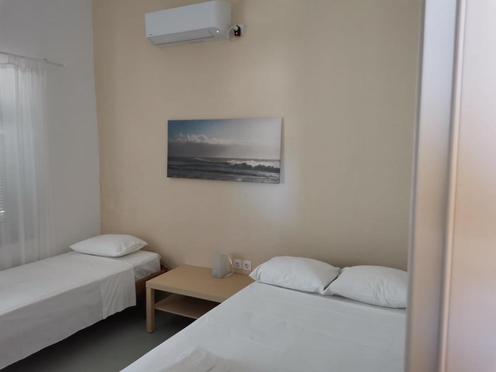 a small room with two beds and a table at Thalassa4 in Andros
