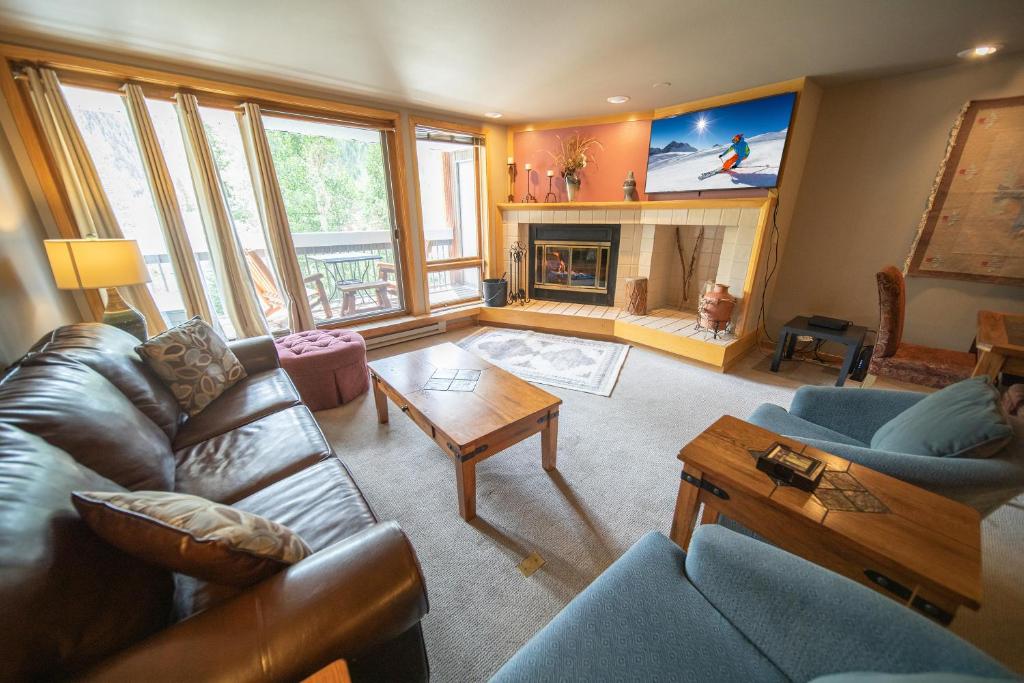 a living room with a couch and a fireplace at Liftside 203 by SummitCove Lodging in Keystone