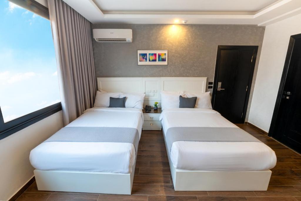 Postel nebo postele na pokoji v ubytování Nile Villa Hotel