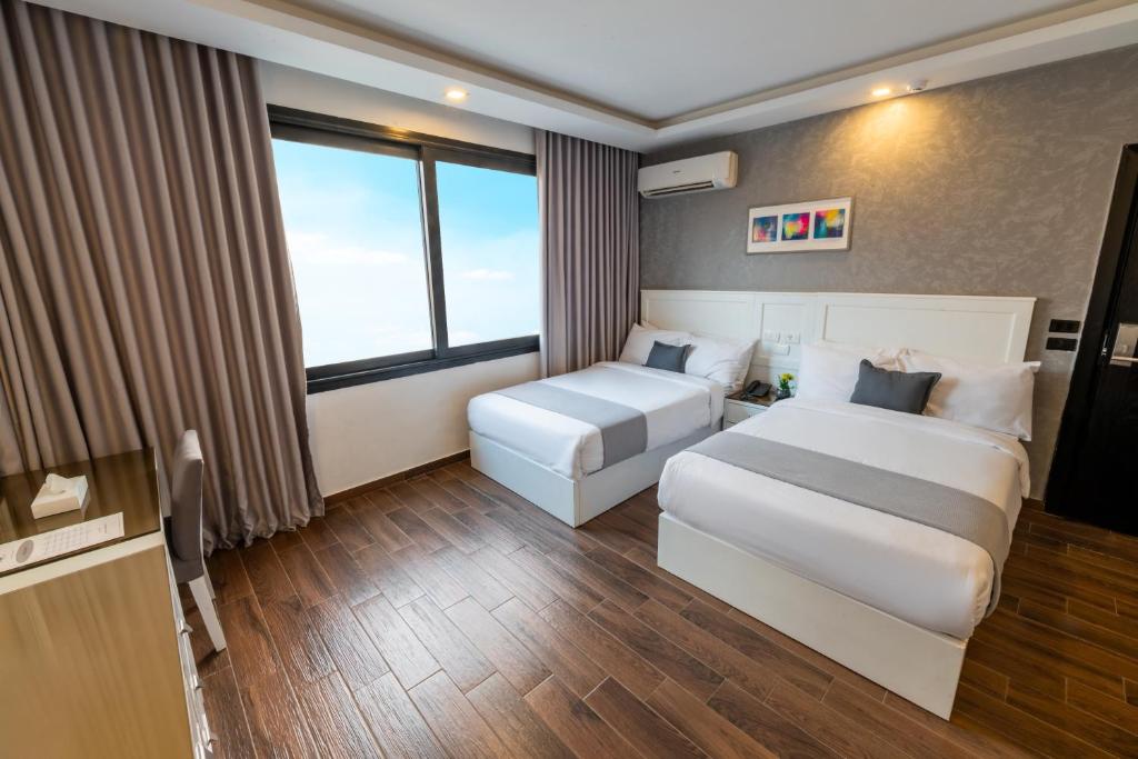 Postel nebo postele na pokoji v ubytování Nile Villa Hotel
