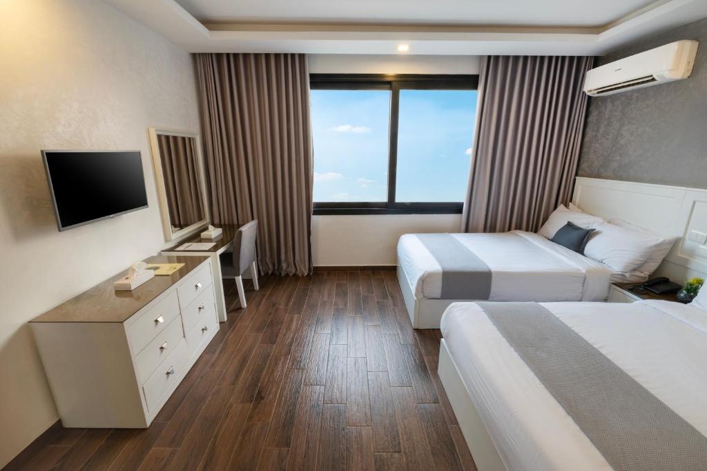 Postel nebo postele na pokoji v ubytování Nile Villa Hotel