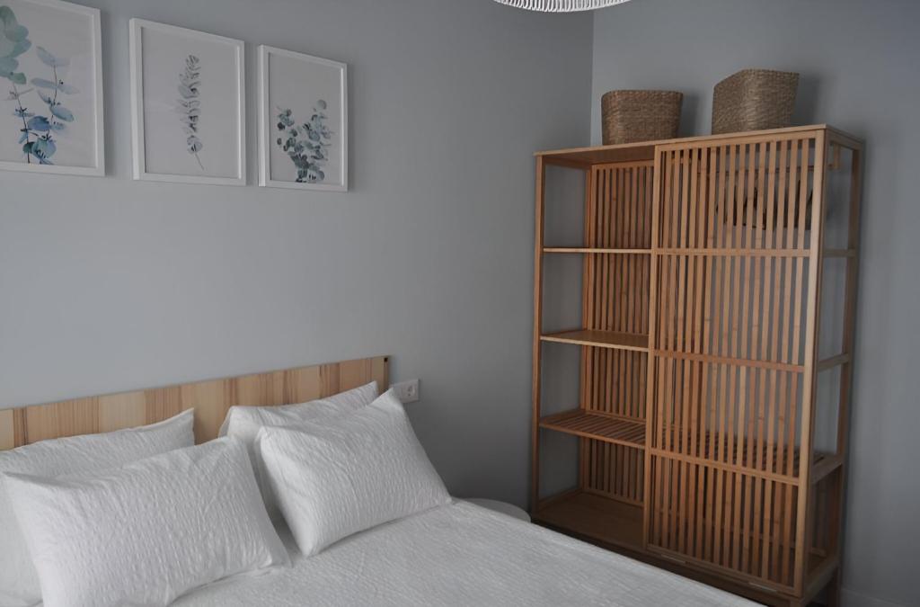 a bedroom with a bed and a wooden book shelf at Vivienda Uso Turistico Zapateria 1 licencia VUT 42120 in Soria
