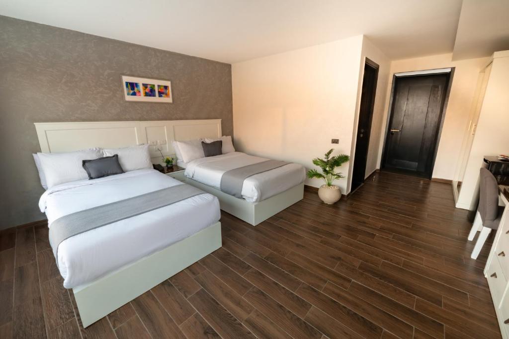 Postel nebo postele na pokoji v ubytování Nile Villa Hotel