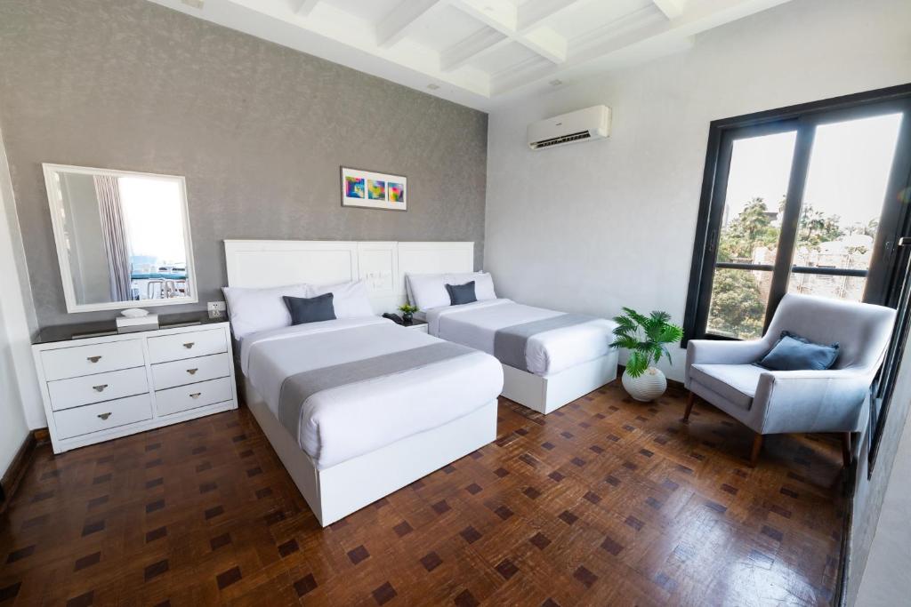 Postel nebo postele na pokoji v ubytování Nile Villa Hotel