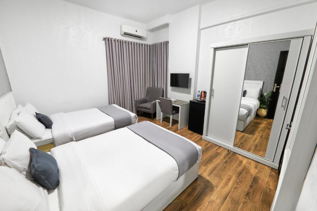 Postel nebo postele na pokoji v ubytování Nile Villa Hotel