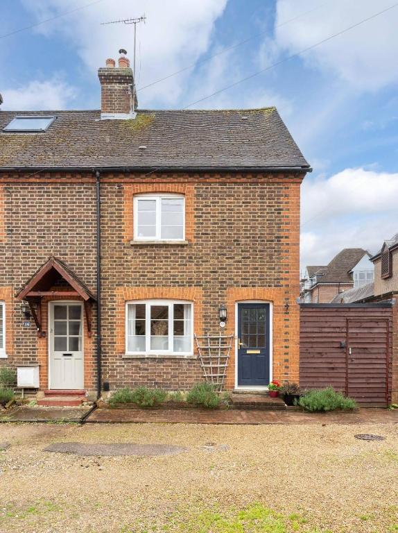 a brick house with a blue door at Quaint 3 bed Cottage in central Dorking with parking in Dorking