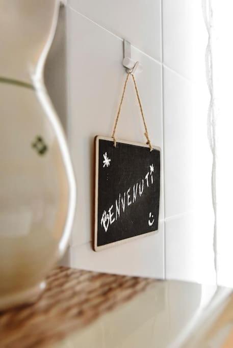 a chalkboard sign hanging on a wall next to a window at 19gradini in Putignano