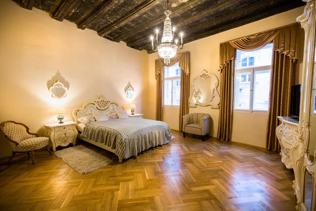 a bedroom with a bed and a chandelier at Apartments U Krále Brabantského in Prague