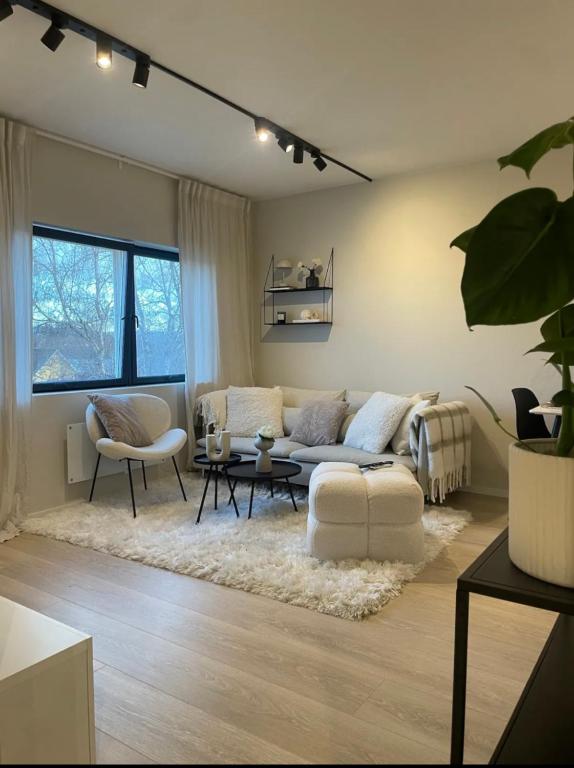 a living room with a couch and a table at Plaza Havstad in Trondheim