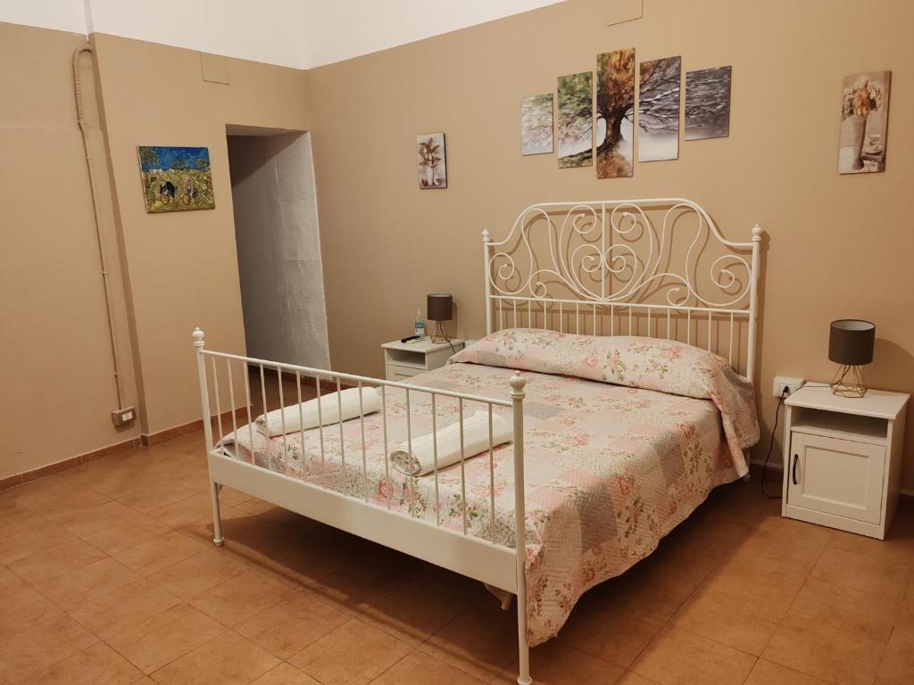 a bedroom with a white bed and two night stands at La casa di Sally in Syracuse