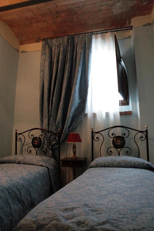 Postel nebo postele na pokoji v ubytování Agriturismo Renaccino