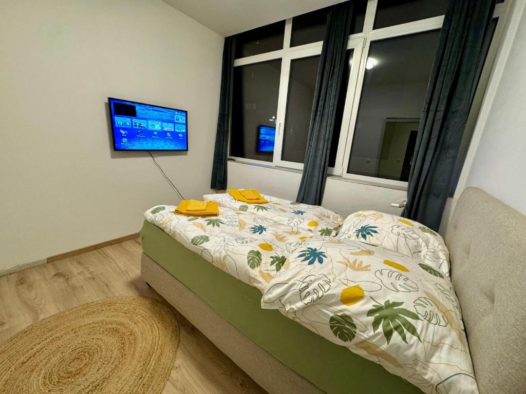a bedroom with a bed and a window at City Ferien Wohnungen 3 in Rosenheim