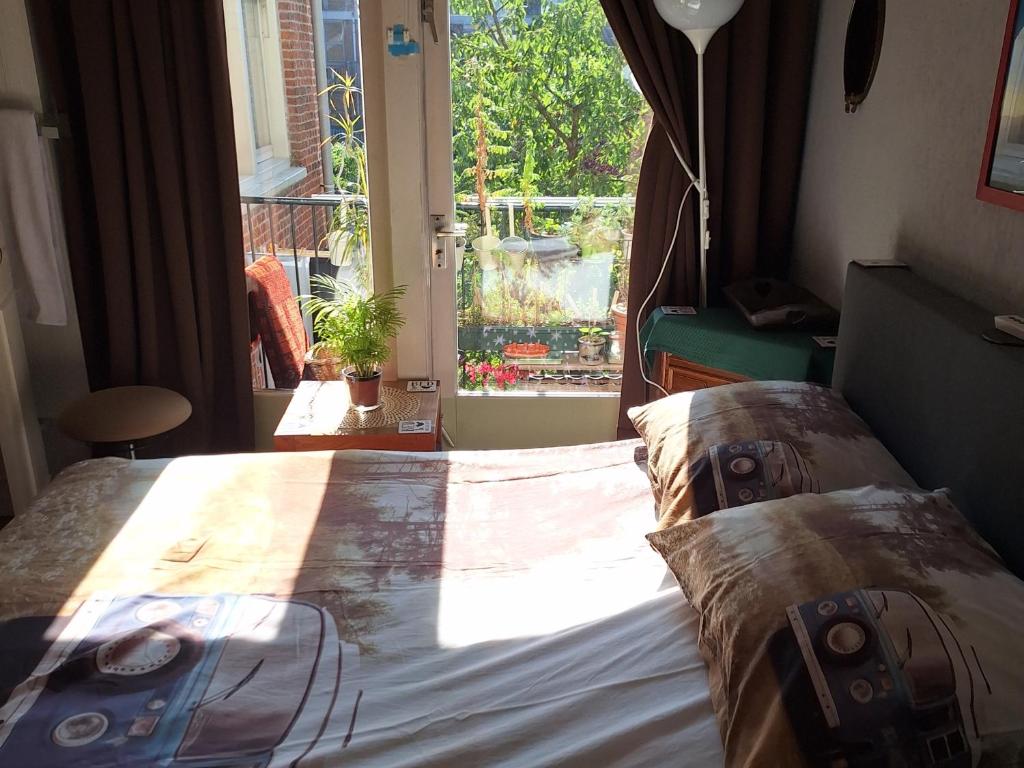 a bedroom with a bed and a large window at Homey Budget Bedroom in Amsterdam