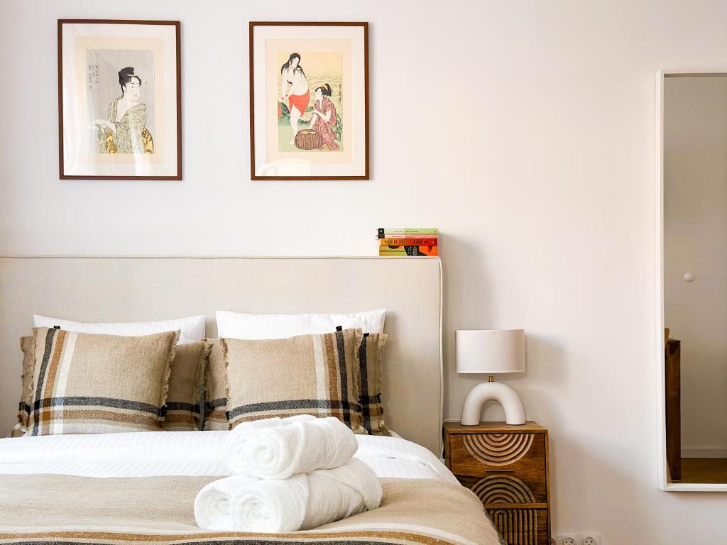 a bedroom with a bed with three pictures on the wall at FLH Boutique Studio in Warsaw
