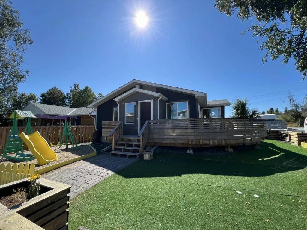a home with a playground and a house at Little holiday home in Yellowknife