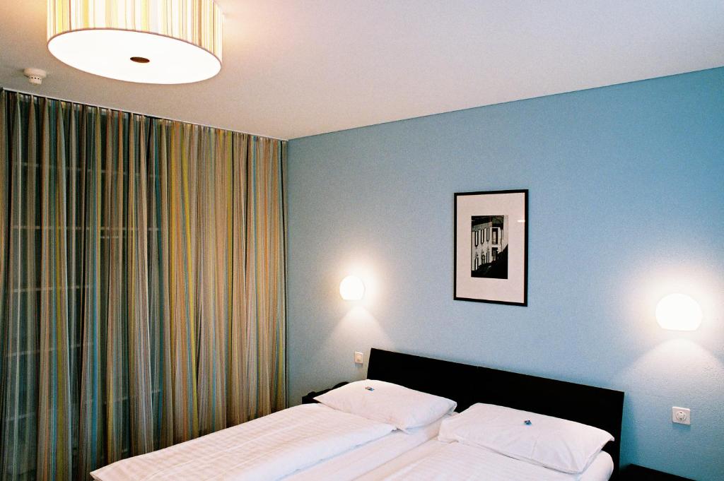Voodi või voodid majutusasutuse Hotel Pestalozzi Lugano toas