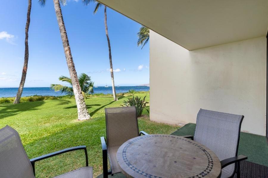 a patio with a table and chairs and the ocean at Sugar Beach Resort, #130 condo in Kihei