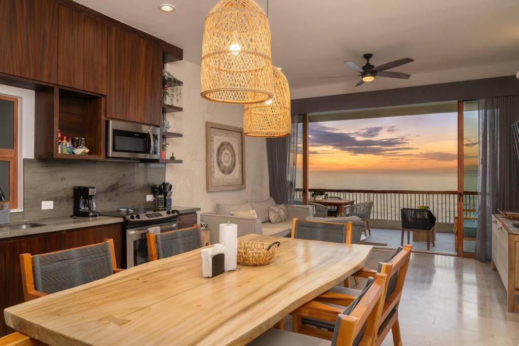 a kitchen and dining room with a dining table with a view at Unique BEACH FRONT condo with concierge in San José del Cabo