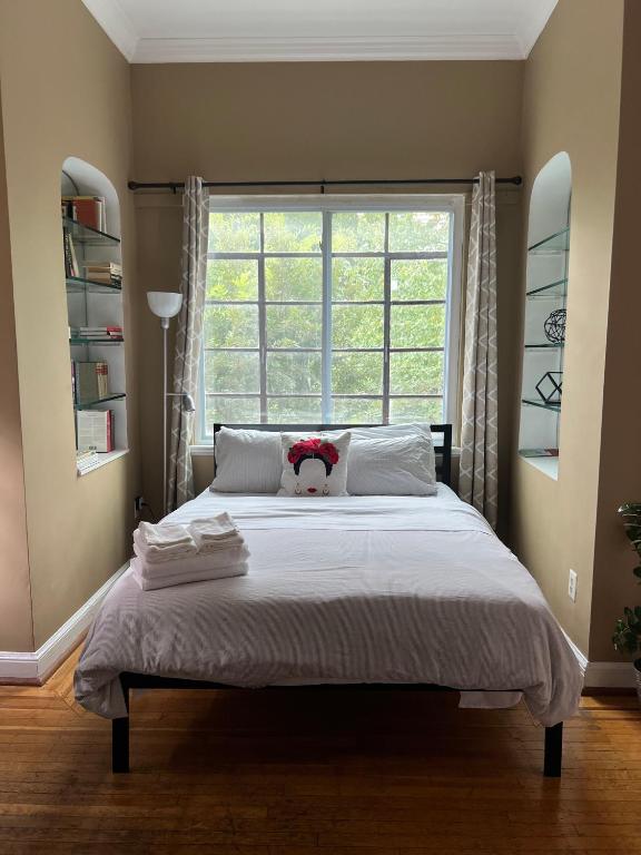 a bedroom with a bed with a teddy bear on it at The Orange House in Washington, D.C.