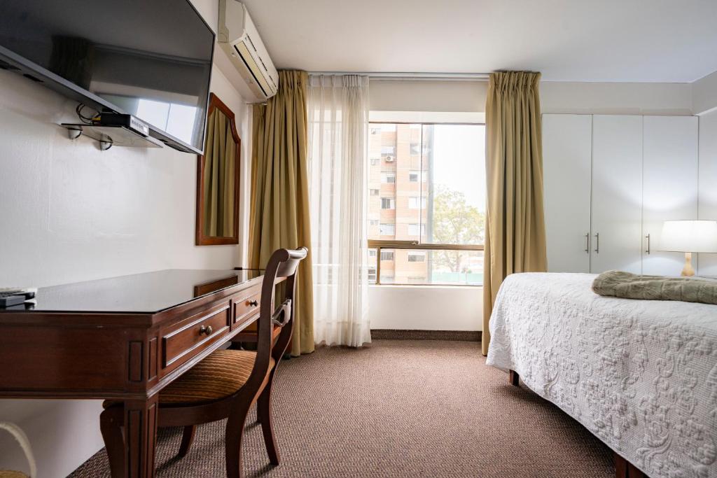 Postel nebo postele na pokoji v ubytování Apart Hotel San Martin
