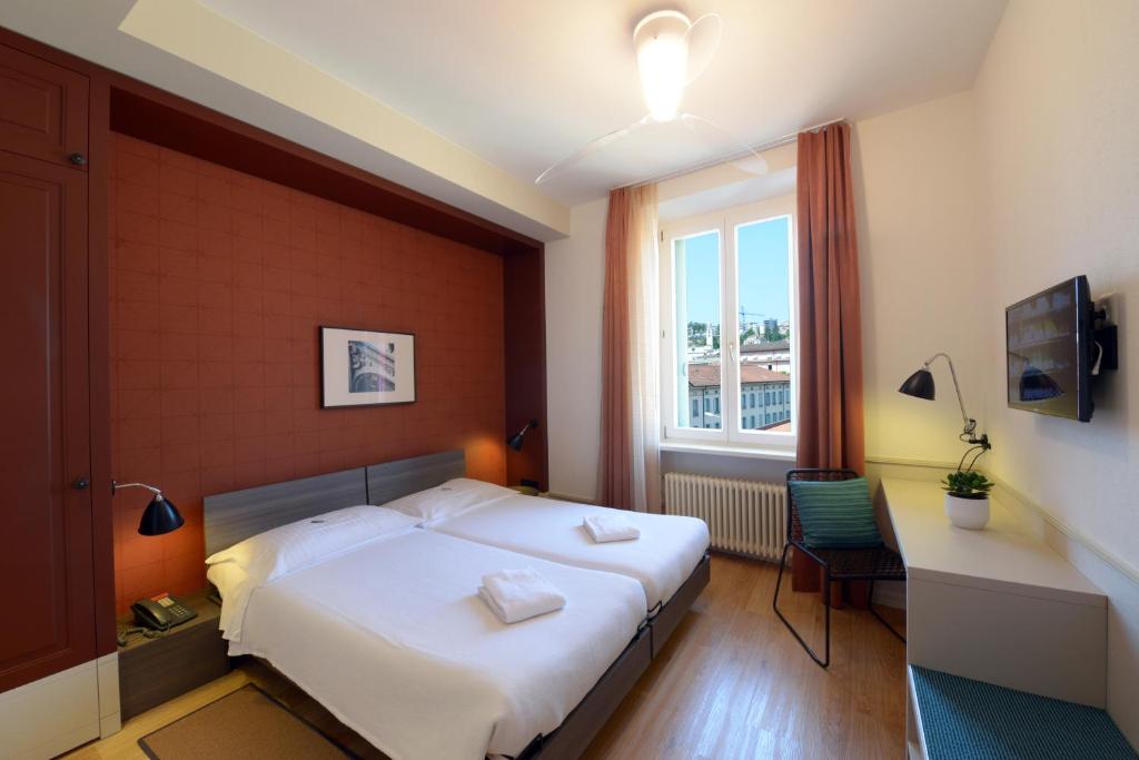 Voodi või voodid majutusasutuse Hotel Pestalozzi Lugano toas