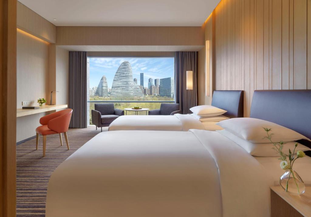 Postel nebo postele na pokoji v ubytování Hyatt Regency Beijing Wangjing