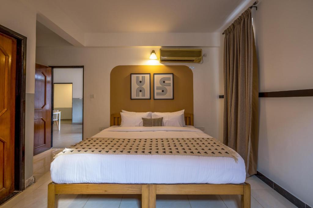 Postel nebo postele na pokoji v ubytování Olive Hotel Palace Road by Embassy Group