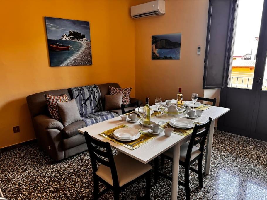 a living room with a table and a couch at MF House in Taormina